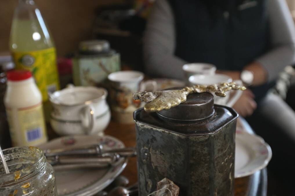 Lump with your tea: The melted brass fitting rests on an antique Bushells caddy in the ktichen of Colleen Keenan and David Lyons. Picture: JAMES WILTSHIRE
