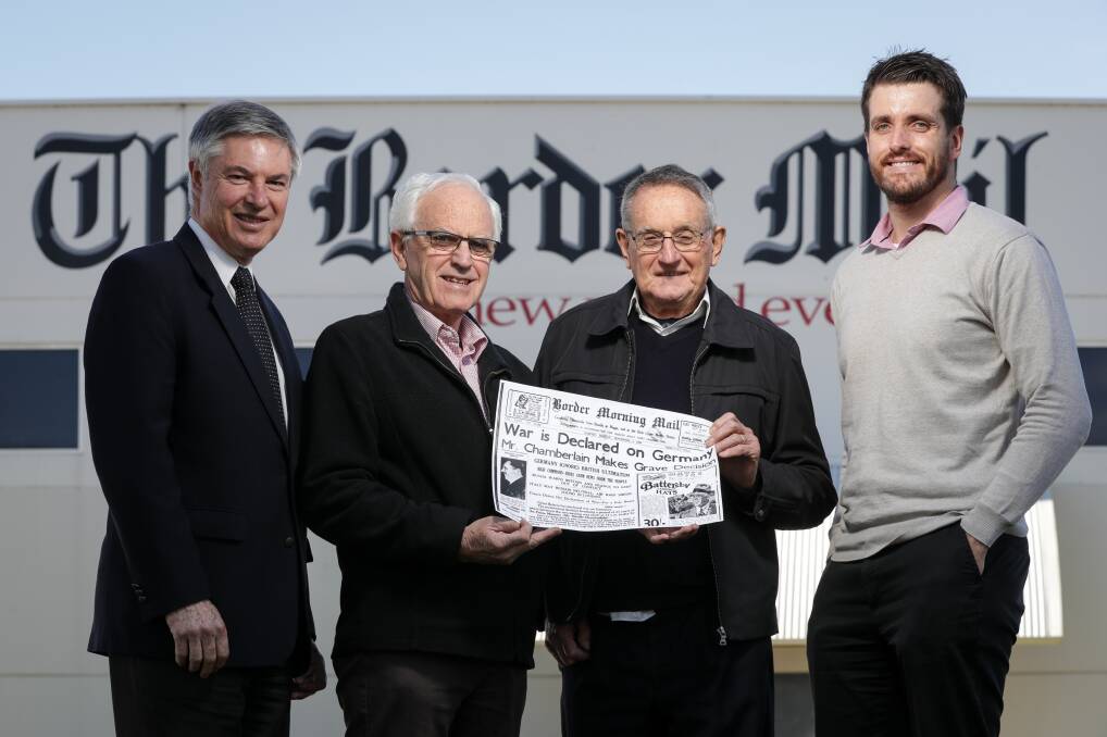 Historic: Greg Aplin, Greg Ryan, Bruce Pennay and Border Mail editor Xavier Mardling with a copy of the paper from the start of World War II. Picture: JAMES WILTSHIRE