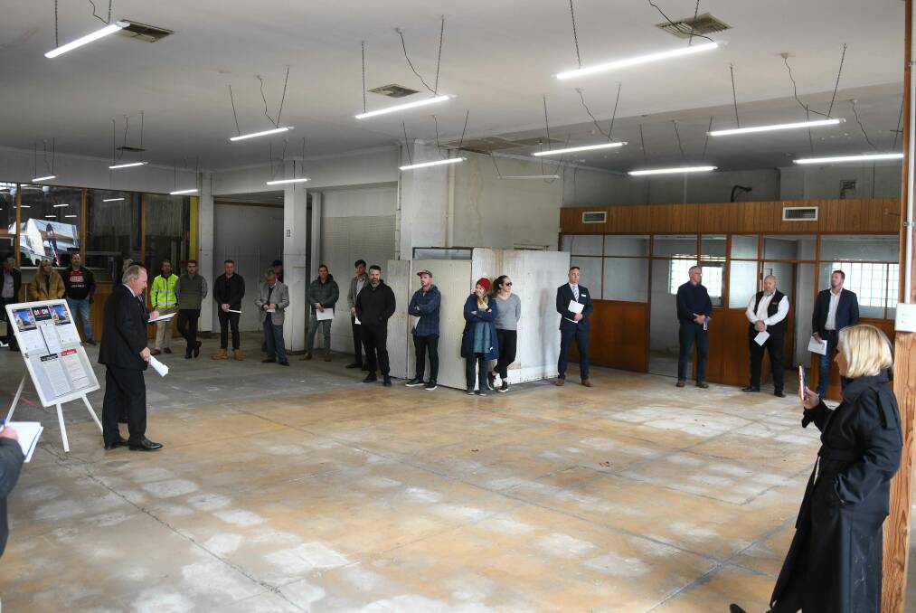Around 40 to 50 people scattered around the former shop floor to watch auctioneer Andrew Dixon conduct the sale of the premises. Picture by Tara Trewhella