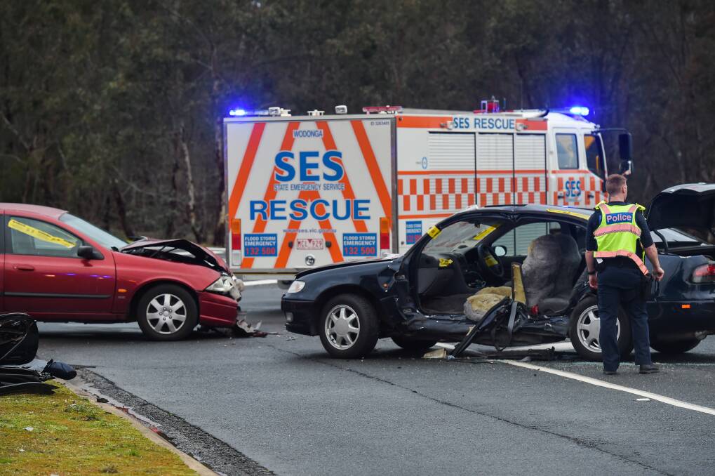Opened up: A Toyota sedan had to have its doors cut off by SES workers after colliding with a Ford Falcon on Monday. The move was required to allow a female passenger to be freed. Picture: MARK JESSER