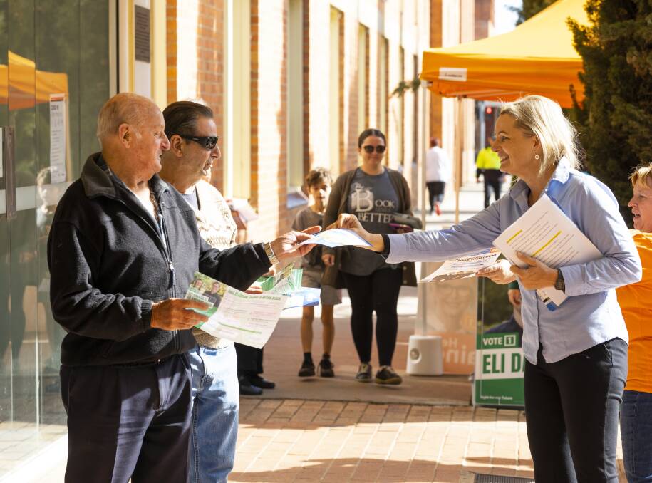 Ballot chasing: Sussan Ley offers her how-to-vote cards to constituents at the Albury prepoll hub on Friday. Picture: ASH SMITH