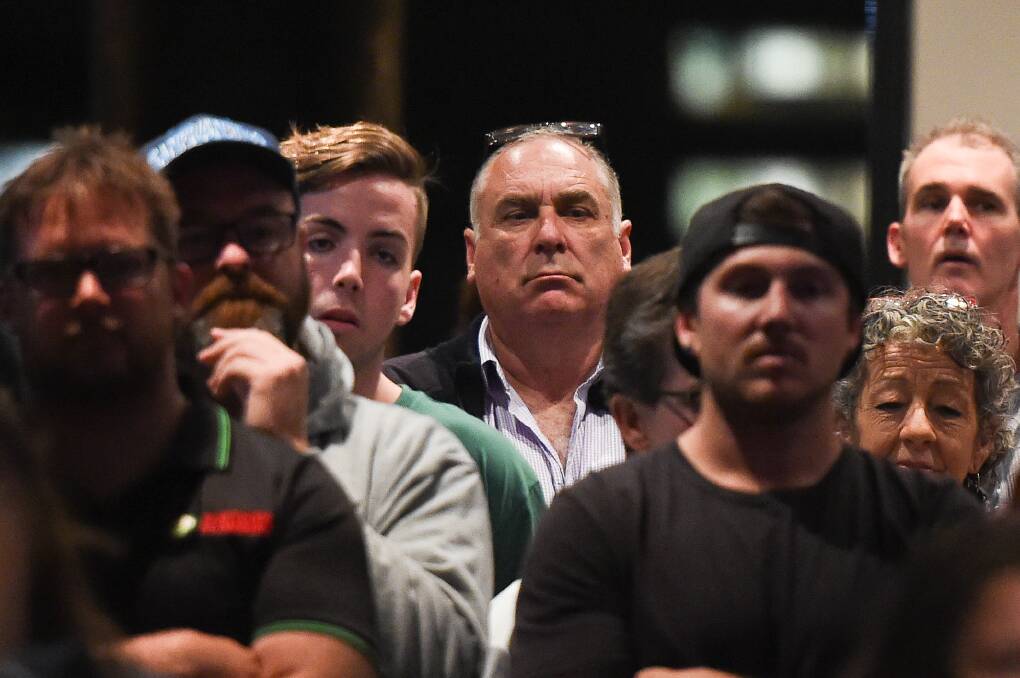 Interested onlooker: Albury councillor Murray King, with glasses resting on his head, watches proceedings at Thursday night's public meeting over pool fees for public aquatic centres. Picture: MARK JESSER