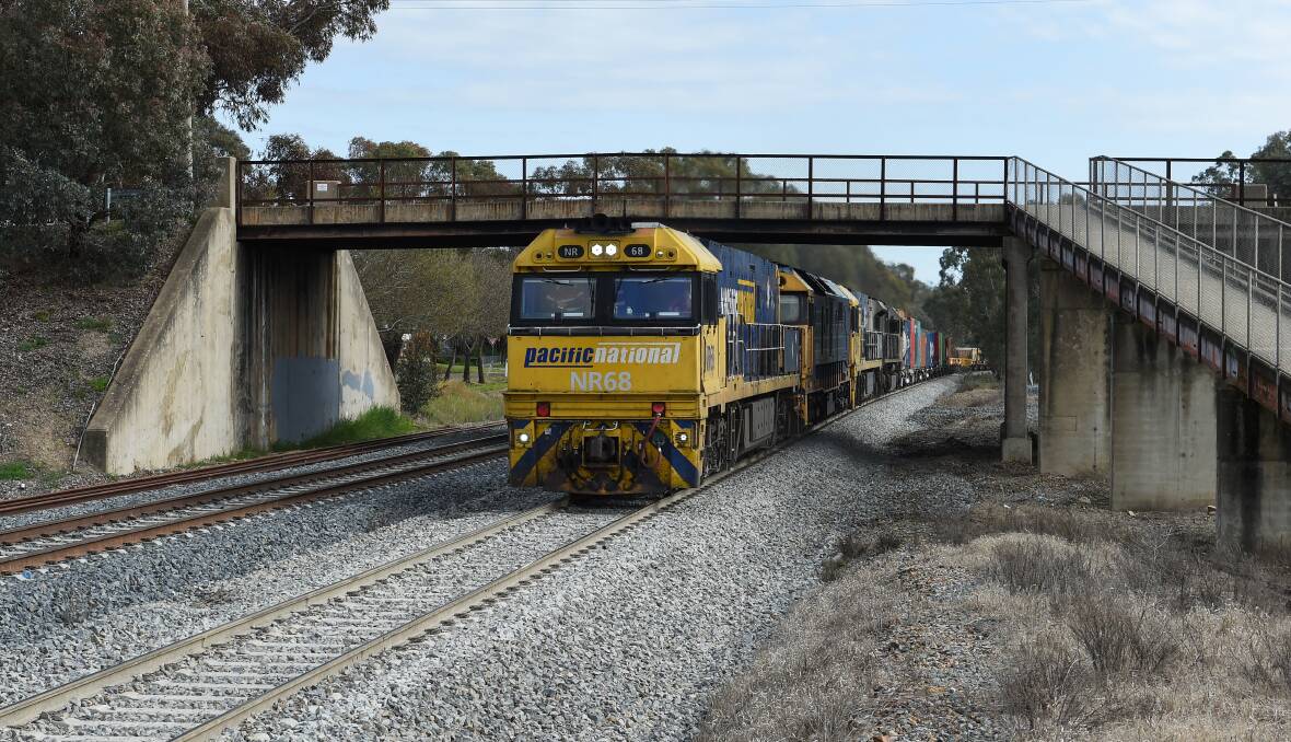 Controversial: A freight train travels under a bridge at Glenrowan which will need to be replaced to allow double stacked wagons to travel through as part of the Inland Rail project. However, locals are concerned the nearby Kelly Siege sites will be badly affected by the plan. Picture: MARK JESSER