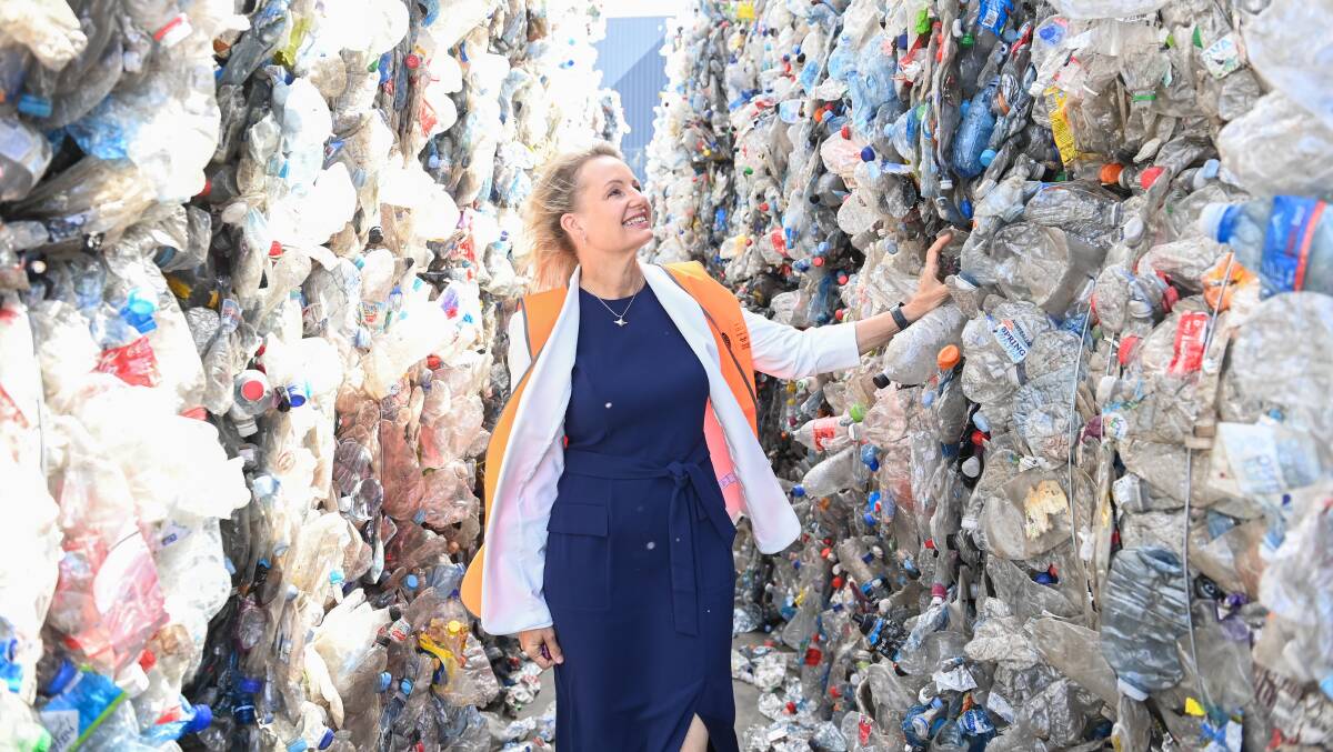 Saved from landfill: Environment Minister and member for Farrer Sussan Ley with some of the bales of plastic bottles waiting to be recycled at the new Ettamogah factory which is a joint venture between Coca-Cola, Asahi, Cleanway and the Pact Group. Picture: MARK JESSER