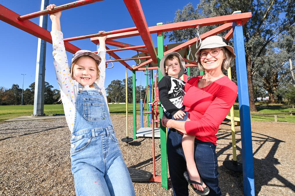 On the list: Poppy, 8 and her brother Patrick, 4, with their nan Vibka Wallder at the play equipment at Thurgoona Oval which is uncovered and a priority to receive shade sails. Picture: MARK JESSER