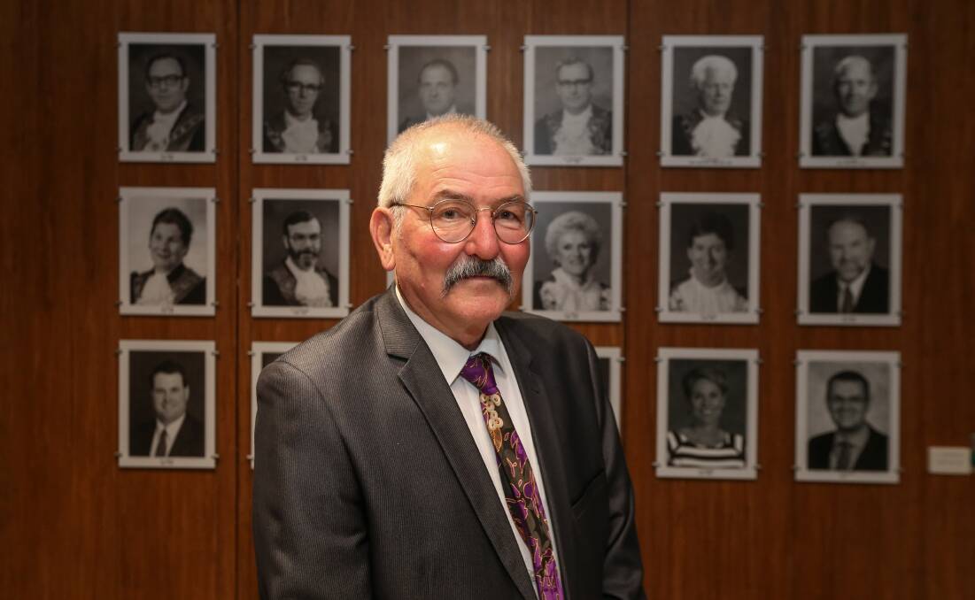 New Wodonga mayor Ron Mildren stands in front of photographs of his predecessors after being elected to lead the city for the next year. Picture by James Wiltshire.