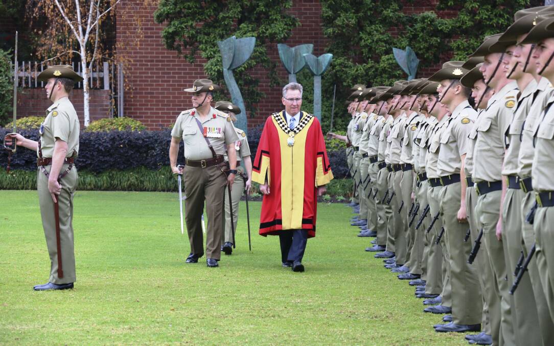Attention: Albury mayor Kevin Mack inspects soldiers in QEII Square on Saturday as part of formalities surrounding the army exercising its right to the freedom of the city. Picture: MANDY BLAND