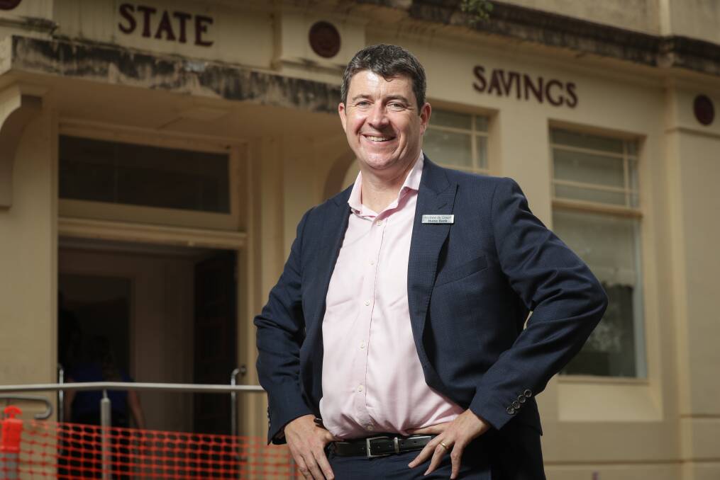 Back to the future: Andrew de Graaff outside the old State Savings Bank which is to become Hume Bank's new home at Yackandandah. Orange netting marks the area where a ramp for disability access is being built. Picture: JAMES WILTSHIRE