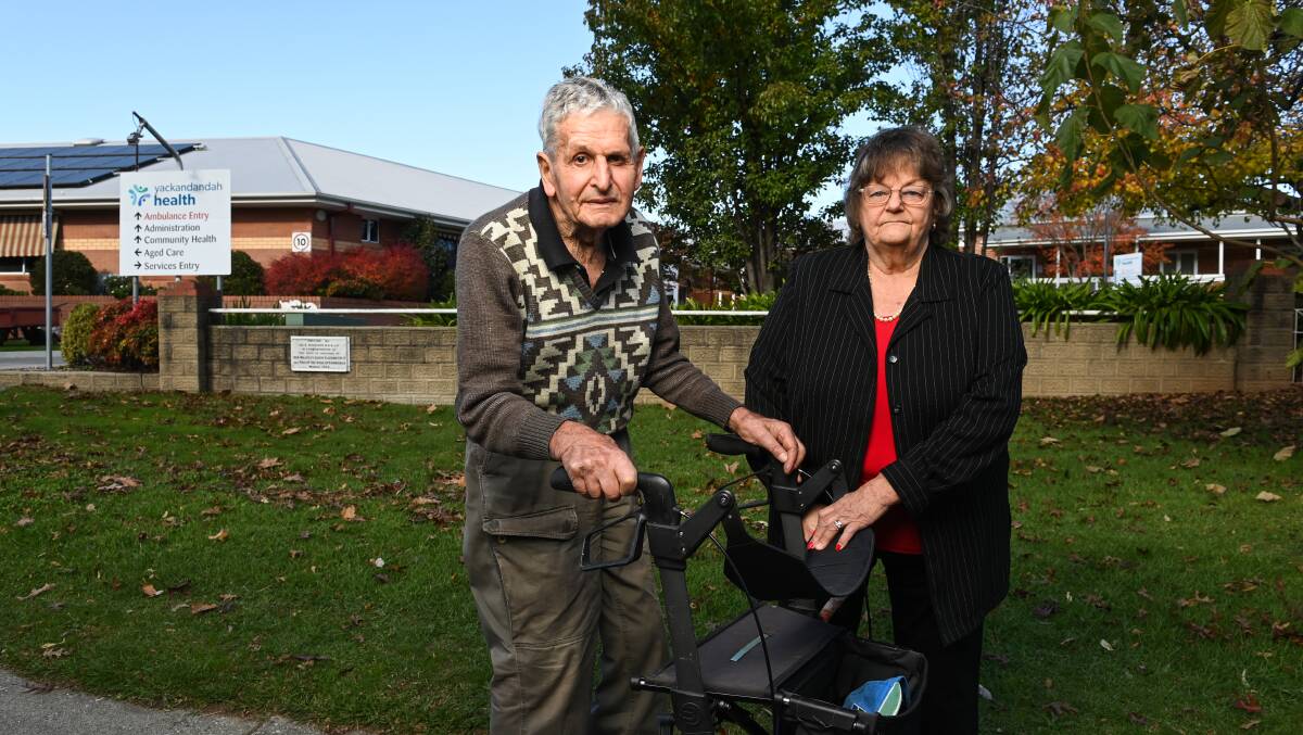 A glum Ron Furze and Jenny Dale outside Yackandandah Health's main entrance yesterday afternoon. The pair devoted decades of voluntary service to the former bush nursing hospital. Picture by Mark Jesser