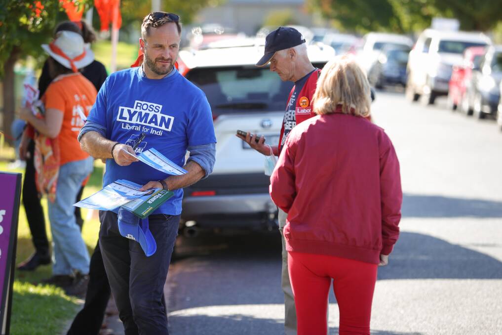 Canvassing: Liberal candidate for Indi Ross Lyman offers his how-to-vote brochure to a voter in Wodonga on Monday. Picture: JAMES WILTSHIRE