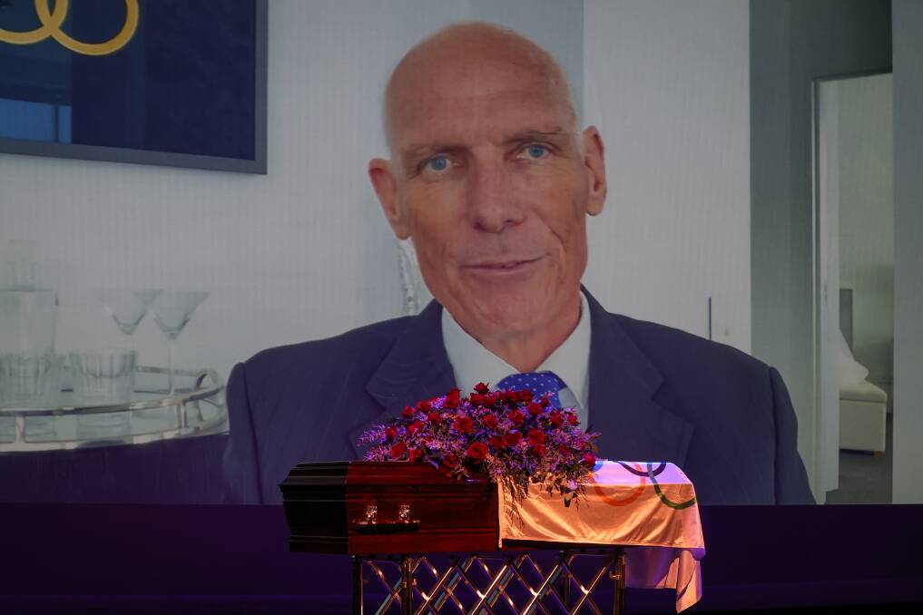 Adieu: Dean Woods delivers his own eulogy as his casket sits in the foreground on the stage of the Wangaratta Performing Arts Centre. Picture: JAMES WILTSHIRE