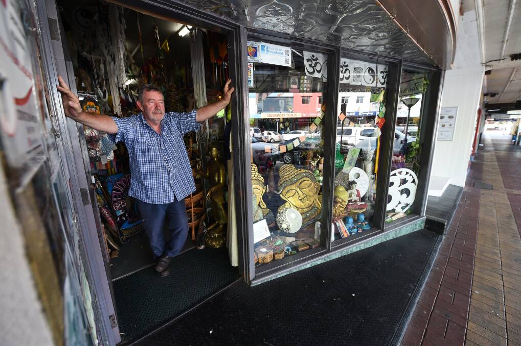 Sad time: Buddha Shop owner Gary Hayward looks mournfully out the front door of his now shut store to a largely deserted Dean Street in on Friday afternoon. Picture: MARK JESSER