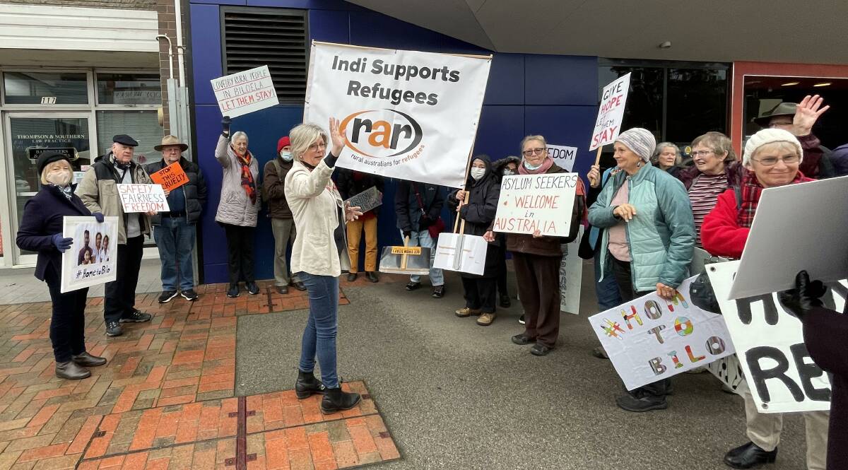 Acknowledgment: Helen Haines waves at a car honking as it passed a vigil for the Sri Lankan family who previously lived in Queensland. Rural Australians for Refugees Wangaratta co-convenor Bern Fraser is at the far left holding a photograph of Priya, Nades, Kopika and Tharunicaa Murugappan.