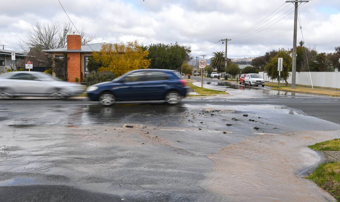Gutters were battling to drain away rainfall on Monday afternoon. In Wodonga, at the intersection of Lawrence and Beardmore streets there were puddles ballooning. Picture by Mark Jesser
