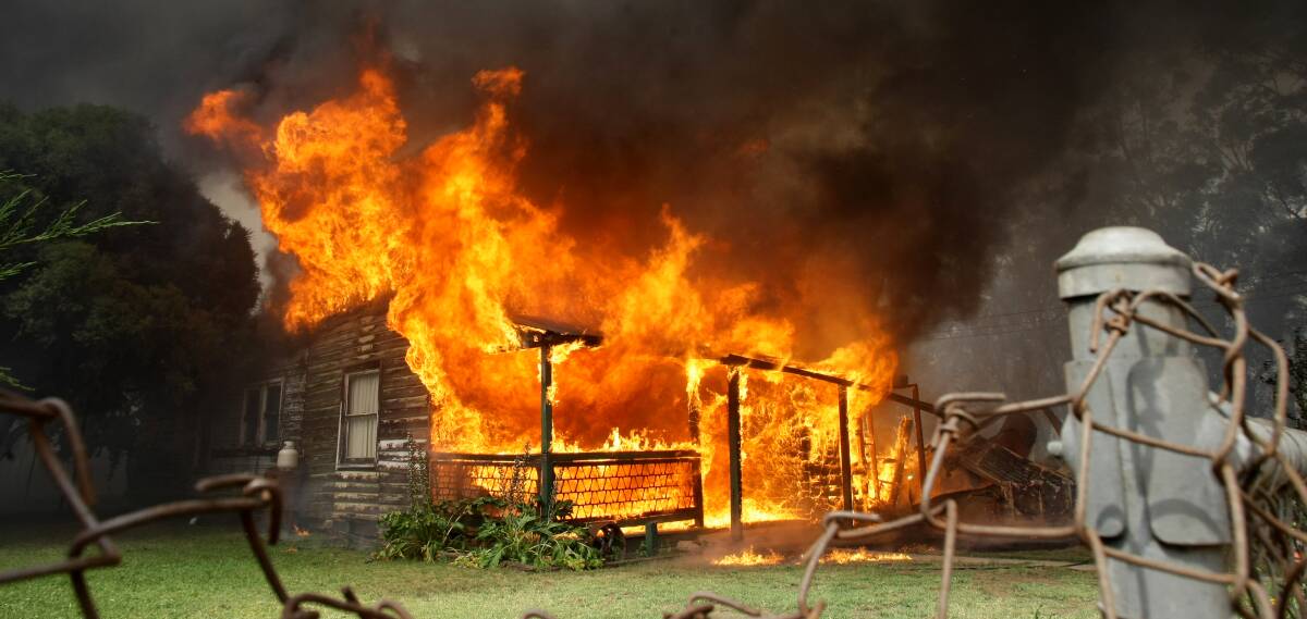 Up in flames: A house is destroyed during the 2009 Gerogery bushfires which are subject to a class action in the Supreme Court of NSW.