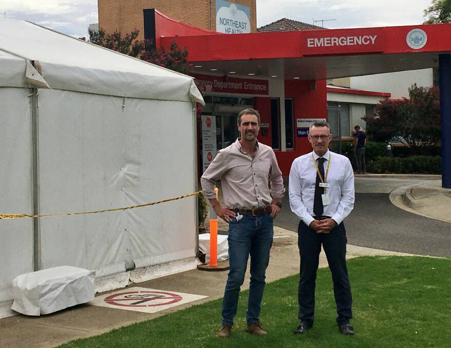 Pitched: Director of emergency at Northeast Health Wangaratta De Witt Oosthuizen and Tim Griffith in front of their new prescreening tent.