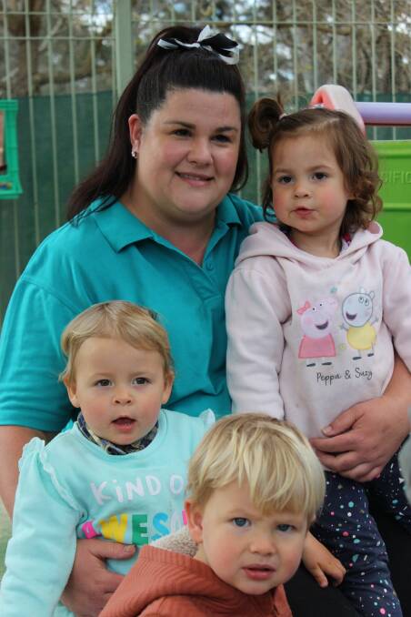 Feeling fulfilled: Caroline Roberts with Elsie, Lila, and Finn, who are among those she educates at Kids On Campus on the grounds of Wodonga TAFE.