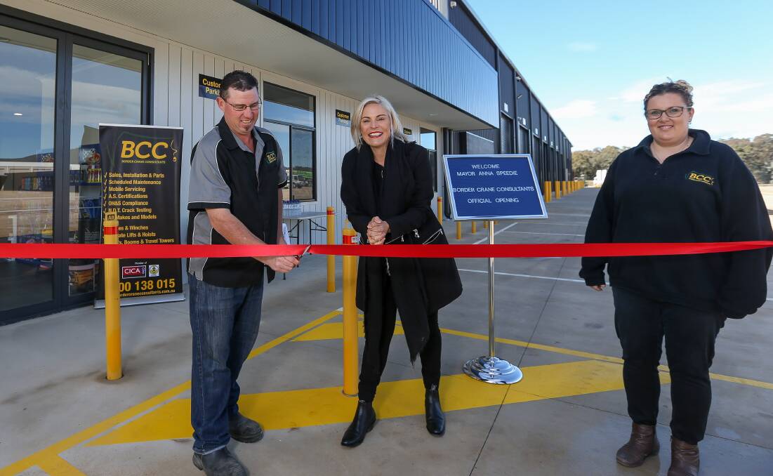 Red ribbon day: Border Crane Consultants director Jason Barry with Wodonga mayor and co-director Melissa Barry at the opening ceremony for the new business site. Picture: TARA TREWHELLA