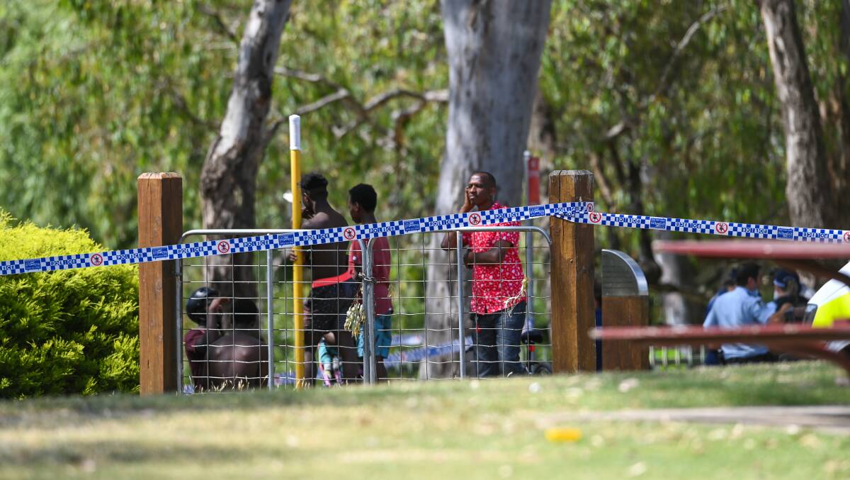 Sad situation: Friends of Mr Lunanga at the Murray River in Albury on the afternoon of Christmas Day after he was reported missing. Picture: MARK JESSER