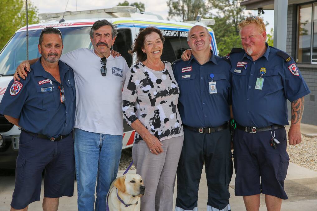 Forever grateful: Karen Evans with husband Peter and paramedic Greg Kay and ambulance community officers Andy McLean and Lee Marple who came to her rescue. The Evans' pet dog Zinna also accompanied them to express gratitude.