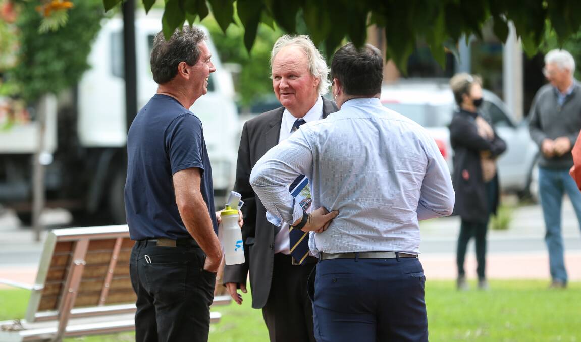 Talking turkey: Auctioneer Andrew Dixon (centre) chats with the man (left) who bid on behalf of Junction Support Services, after the property was passed in. Picture: JAMES WILTSHIRE