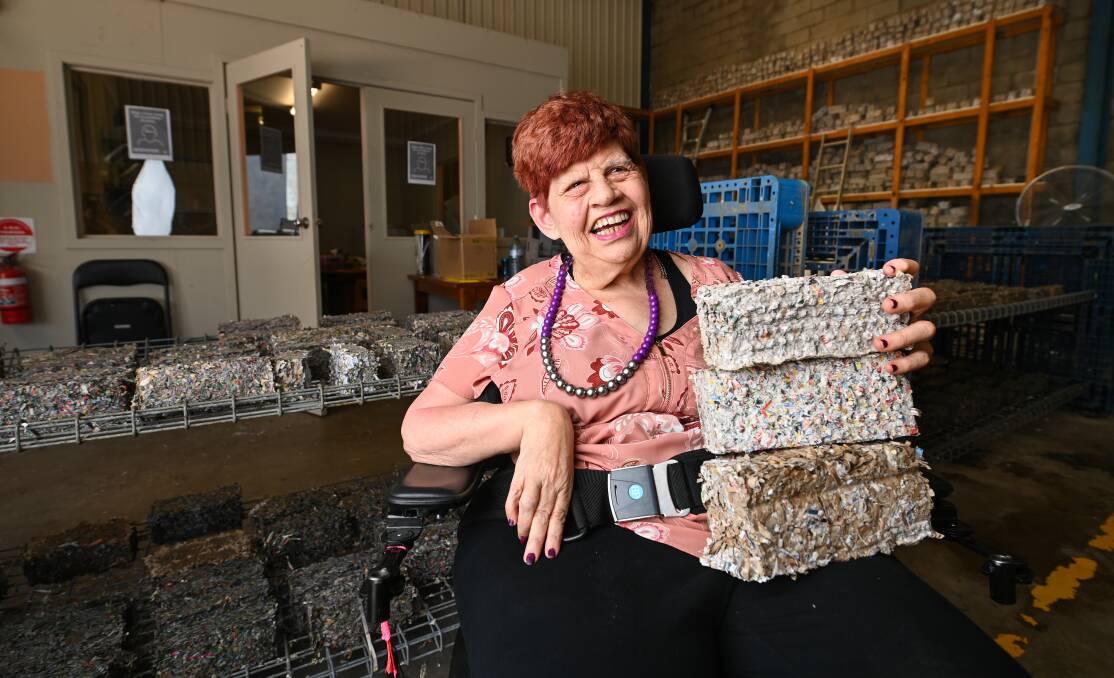 Potential beneficiary: Liz Rollings, who has an intellectual disability, with some of the bricks that have been made with shredded cardboard for use as fire lighters. She may be employed at the new production site in Lavington. Picture: MARK JESSER