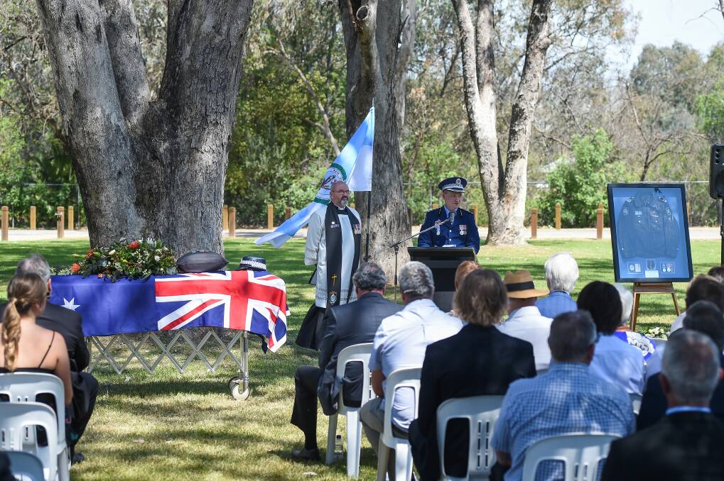 Special setting: The Murray River at Hovell Tree Park provided the backdrop for Detective Senior Constable Marg Saunders' funeral. Police chaplain the Reverend Canon Alan Kelb watches as Acting Superintendent Owen Hill delivers his valedictory. Picture: MARK JESSER