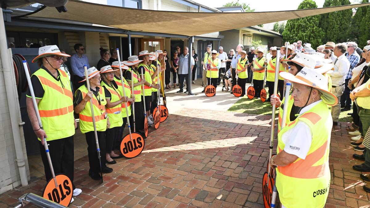 Supervisors who man 22 school crossings spread through Wodonga form their guard of honour ahead of the coffin being brought out. Picture by Mark Jesser 