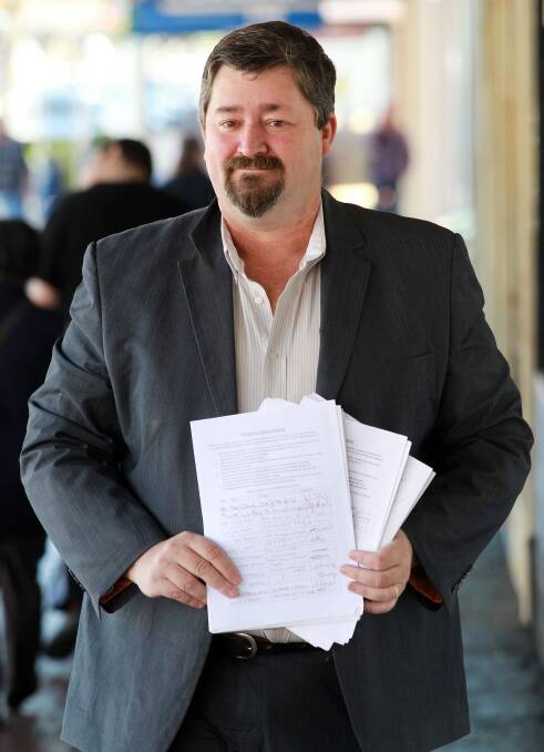 Flashback: Darren Cameron in 2014 with a petition he presented to Albury Council. It had 500 signatories backing the return of a hard waste collection.