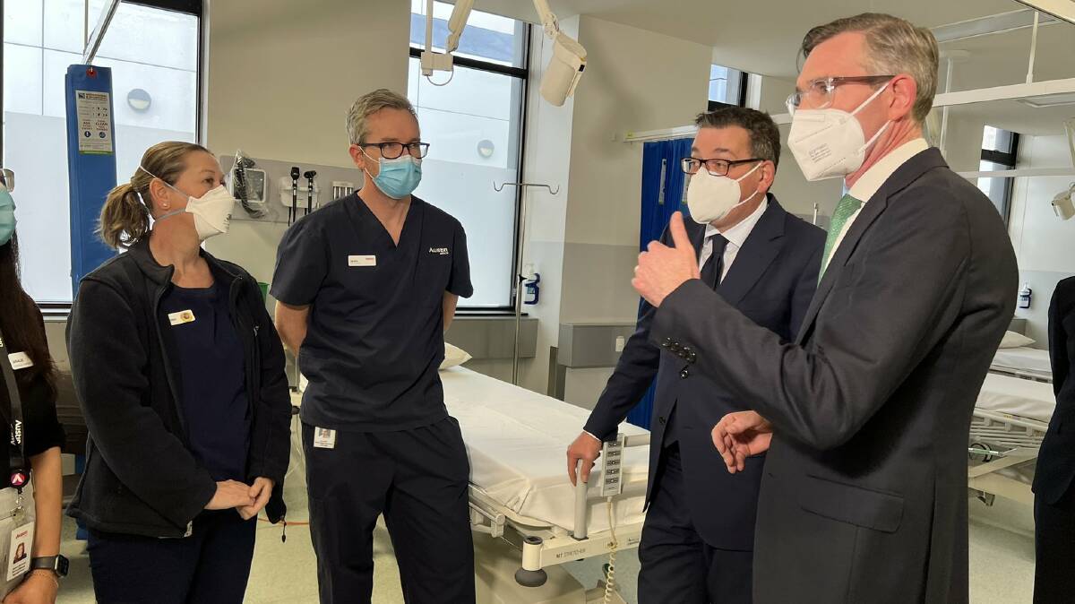 Workers at the Austin Hospital in Melbourne speak to Victorian Premier Daniel Andrews and his NSW counterpart Dominic Perrottet in Melbourne on Tuesday. Picture from Twitter.