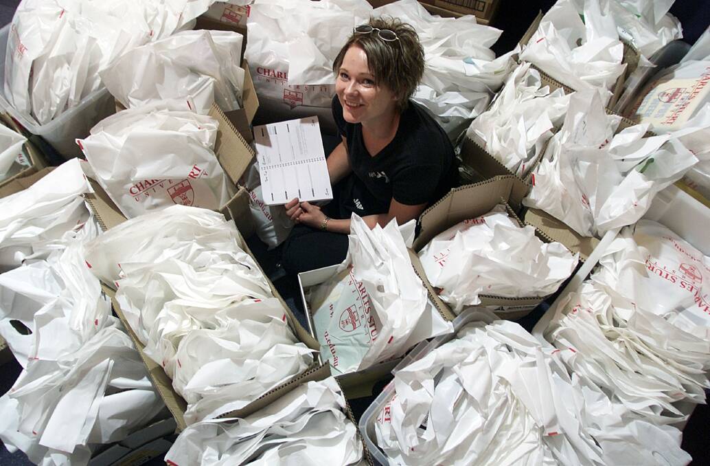 Flashback: Jo Holt helps package Orientation Week bags in 2002. They feature Charles Sturt University's name which is facing the chop to Sturt University.