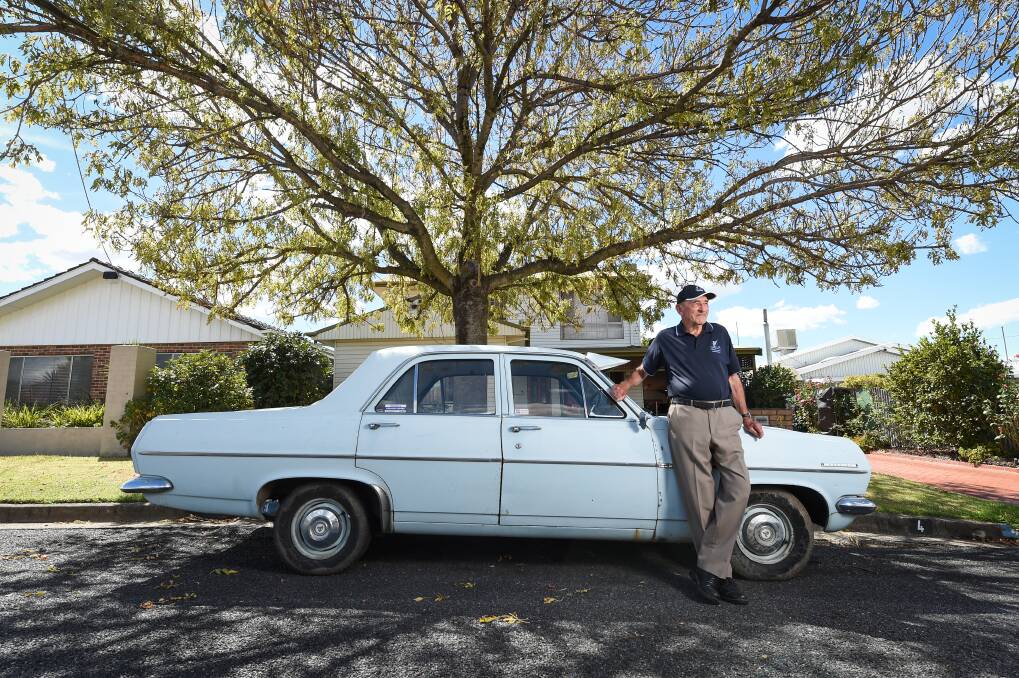 Good set of wheels: Norm Cook with the HR Holden he bought new in 1967 with the money he made working at Uncle Ben's which opened in the same year. Picture: MARK JESSER