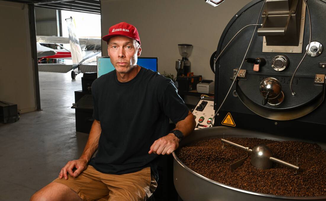 Jason Dowding with the equipment he set up in a room in the Albury airport precinct to roast coffee beans. Picture by Mark Jesser 