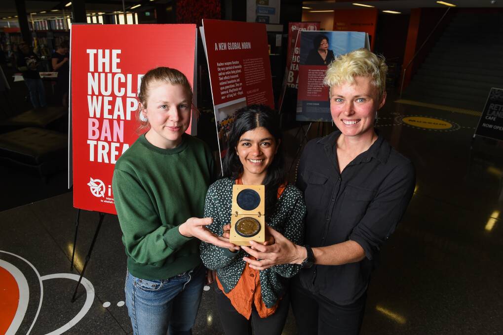 Nobel effort: Alex, Harris, Lavanya Pant and Gem Romuld with the peace prize medal at the Albury library on Monday. Picture: MARK JESSER 