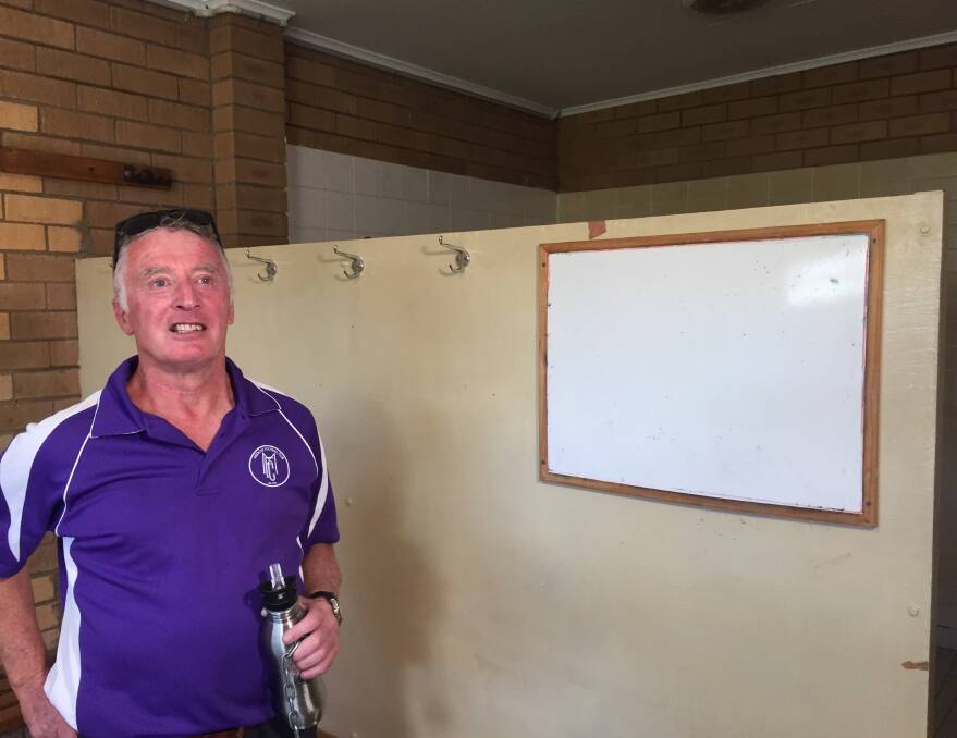 In need of change: Melrose soccer club president David Pye stands before a partition which he installed to divide showers from the rest of the home changerooms.   