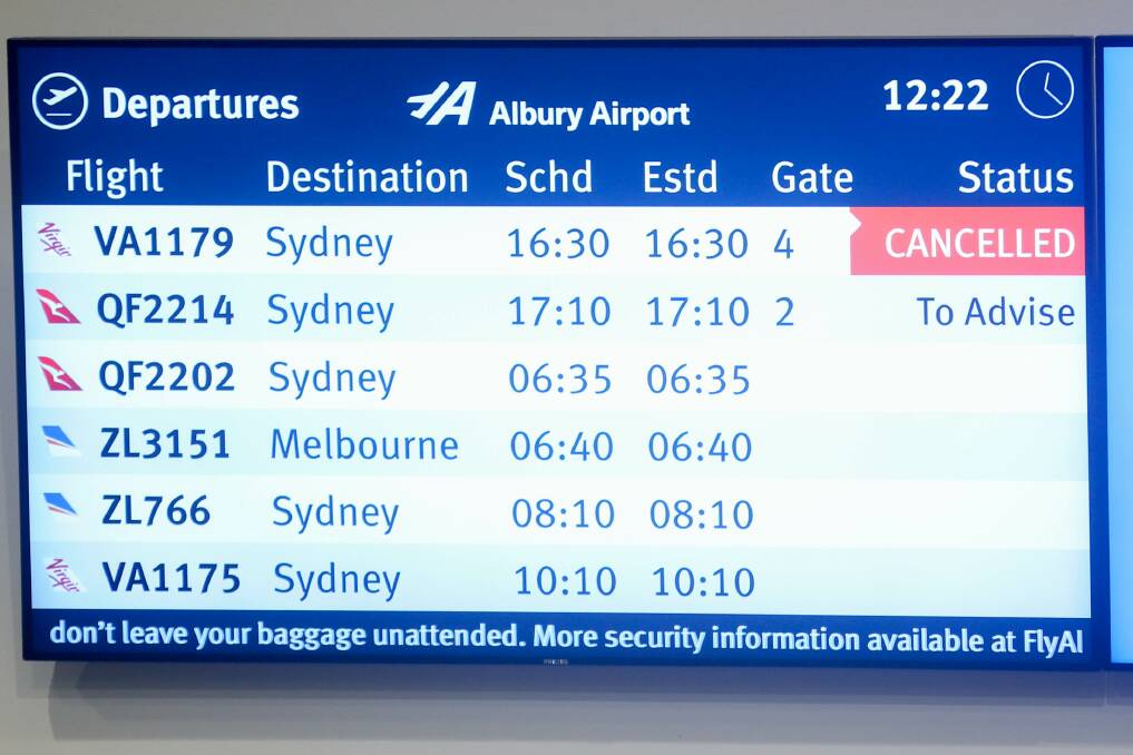 Frustrating sight: The departures board at Albury airport on Monday showing the impact of smoke on flights. Picture: TARA TREWHELLA