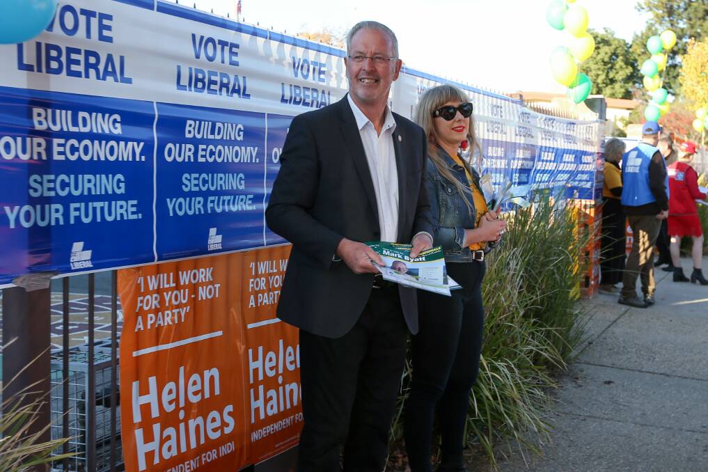 On the hustings: Mark Byatt hands out how-to-vote papers at St Augustine's Primary School in Wodonga on Saturday. Picture: TARA TREWHELLA