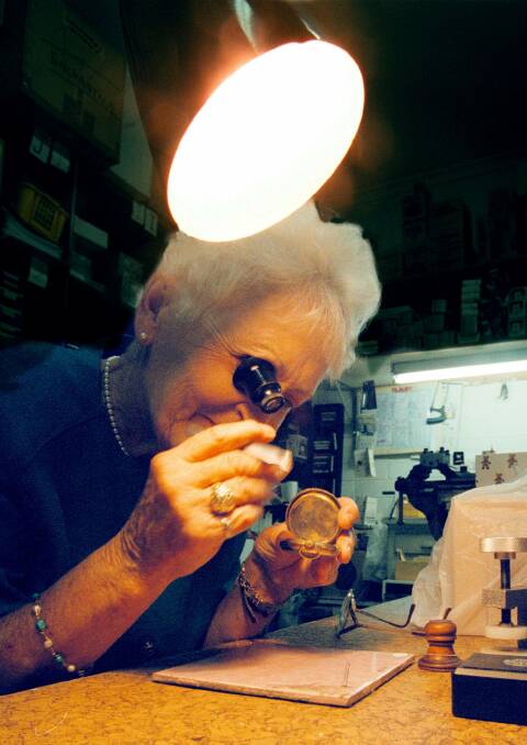 Full of focus: Flora McWaters at the bench examining a fob watch under a magnifying glass in 1998.
