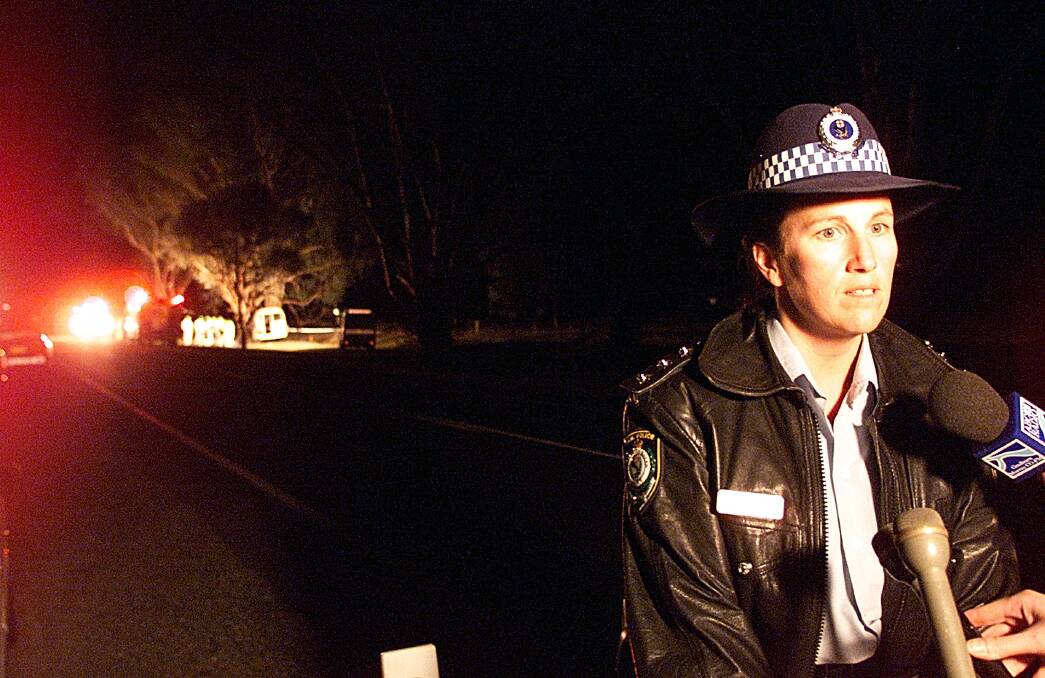 At the front line: As an acting Inspector, Marg Saunders addresses the media at the scene of a fatal bus crash at Splitters Creek in 2002.