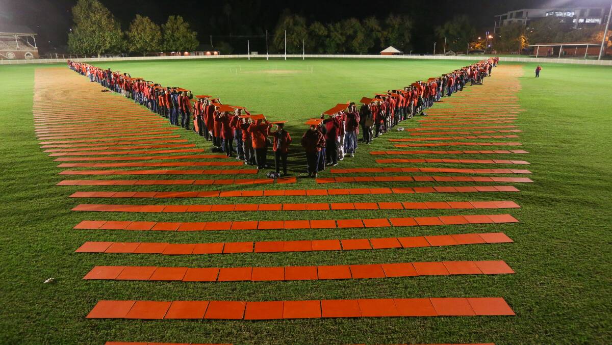 Flashback: Volunteers from across the Border gather at the Albury Sportsground in 2016 to create a giant v to underline what they do.
