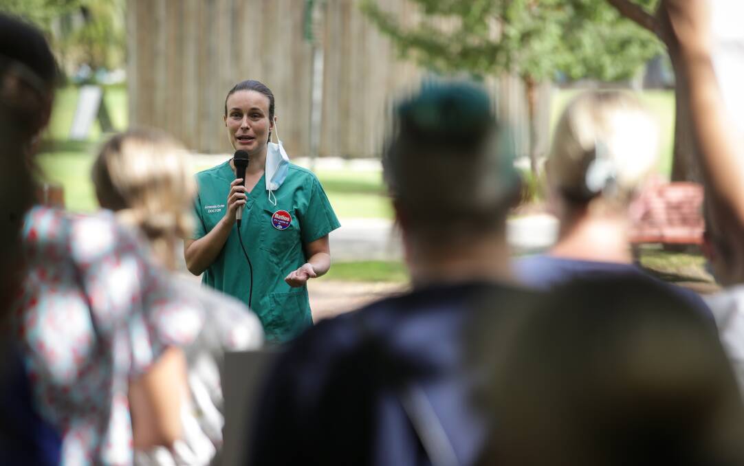 Amanda Cohn, in her scrubs, addresses a rally in 2022 before her entry into parliament last year. She spoke of knowing the Albury hospital "back to front" in her recent speech seeking government documents.