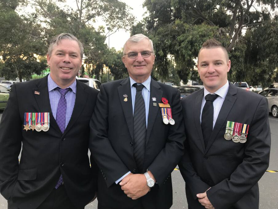 Trekkies: Tony Graham, wearing medals of kin who served in New Guinea during World War II, with Alex and Jamie Wolf outside the SS&A Club on Anzac Day this year. 