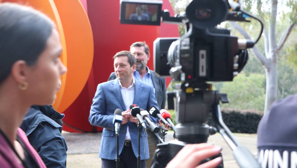 Facing questions: Victorian Opposition leader Matthew Guy is joined by Liberal member for Benambra Bill Tilley at a media conference on Wodonga's Lincoln Causeway on Friday.