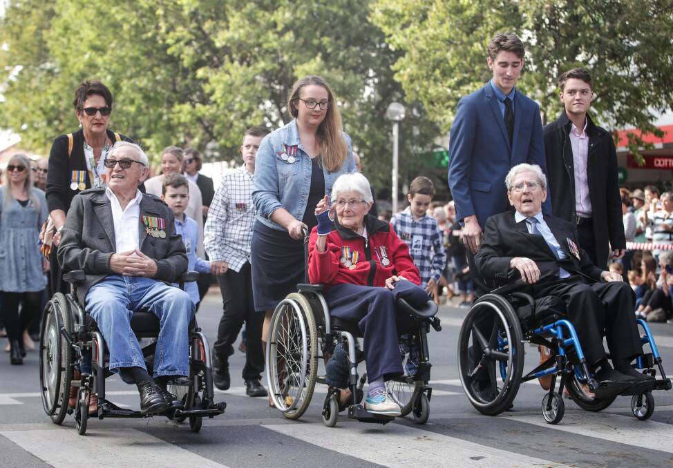History's witnesses: World War II participants Lindsay Poy, Elsie Crawford and Jim Purvey are wheeled down Dean Street.