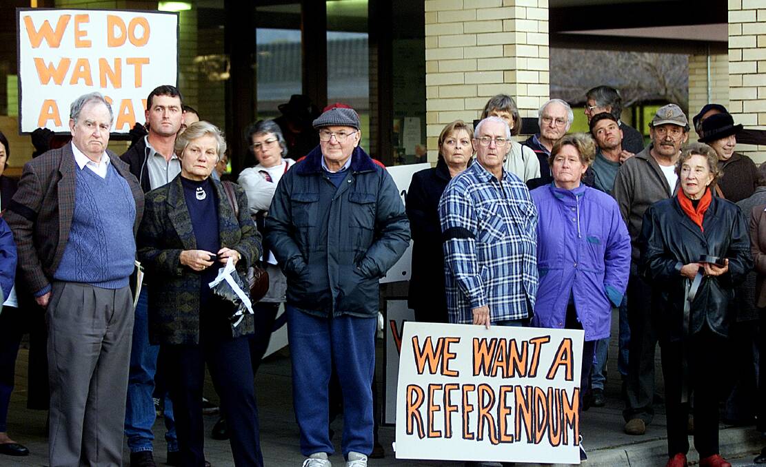 Signs of anger: Merger opponents, including past and future councillors Bill Buckpitt and Ross Coyle, outside the Wodonga Civic Centre in June 2001.