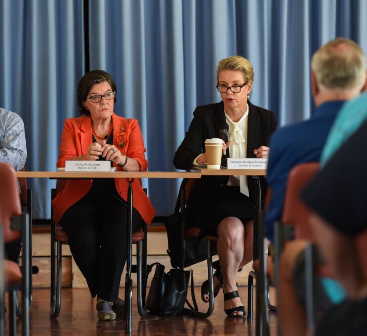 At the same table: Cathy McGowan and Bridget McKenzie share a platform at a dairy industry discussion at Tangambalanga in December 2016.