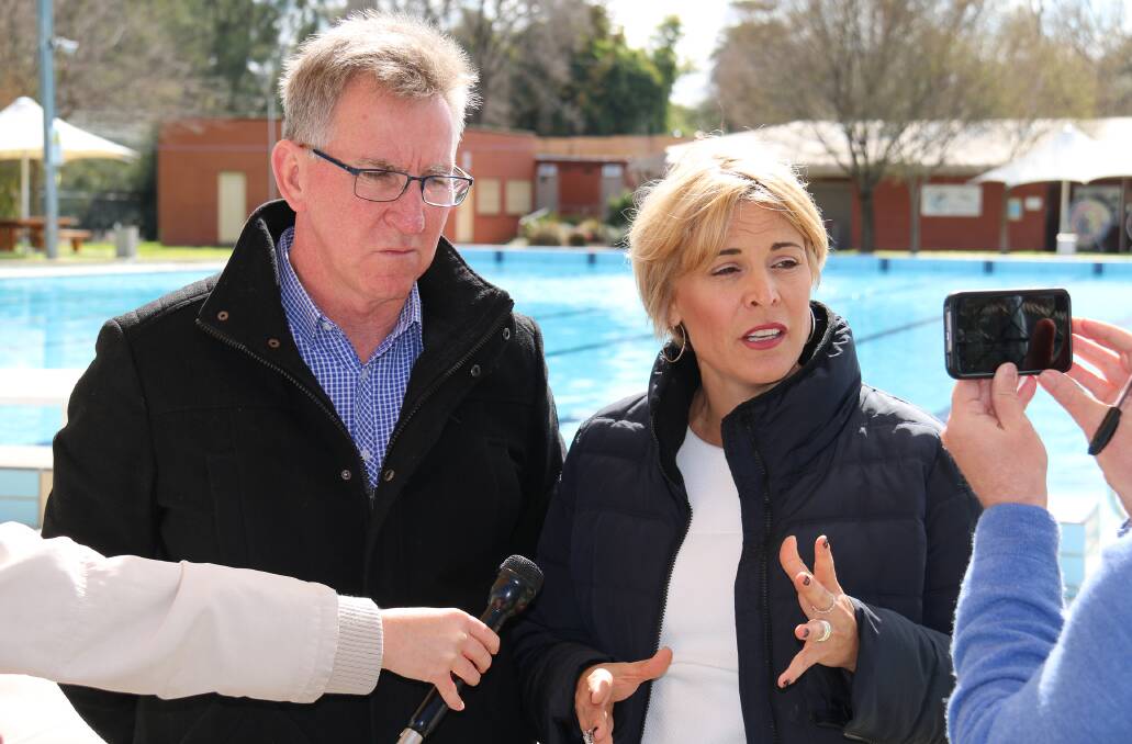 As one: Mayors Kevin Mack and Anna Speedie speak to the media at Albury pool about the councils combining contracts for pool management in their cities.