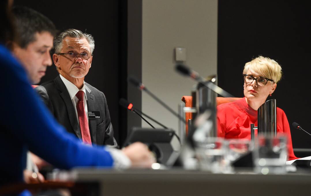 Crossing swords: Anna Speedie eyeballs Tim Quilty as council manager Leon Schultz looks on at a council meeting earlier this year. 