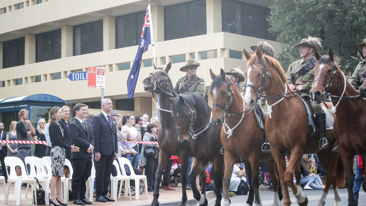 Outset: Lighthorse Association members lead Albury's Anzac Day parade as dignitaries, including acting Albury mayor Amanda Cohn and Albury MP Justin Clancy, watch on.