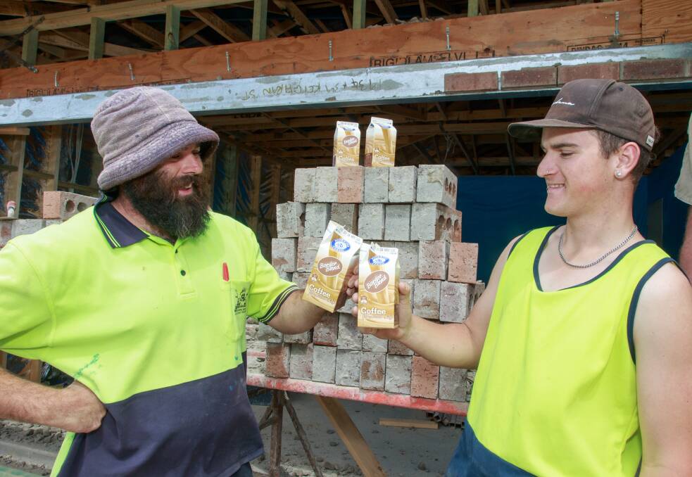 Cheers: Bricklayers Luke Potter and Brad Porter taste test the new Border Blend iced coffee at a White Box Rise building site in Wodonga on Friday. Picture: SIMON BAYLISS